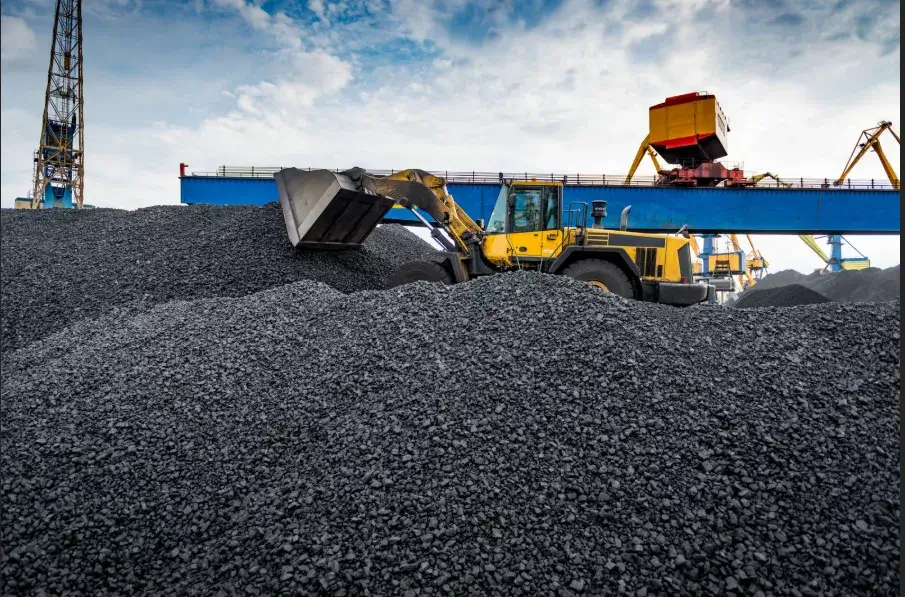 Front loader moving coal at an industrial coal handling site