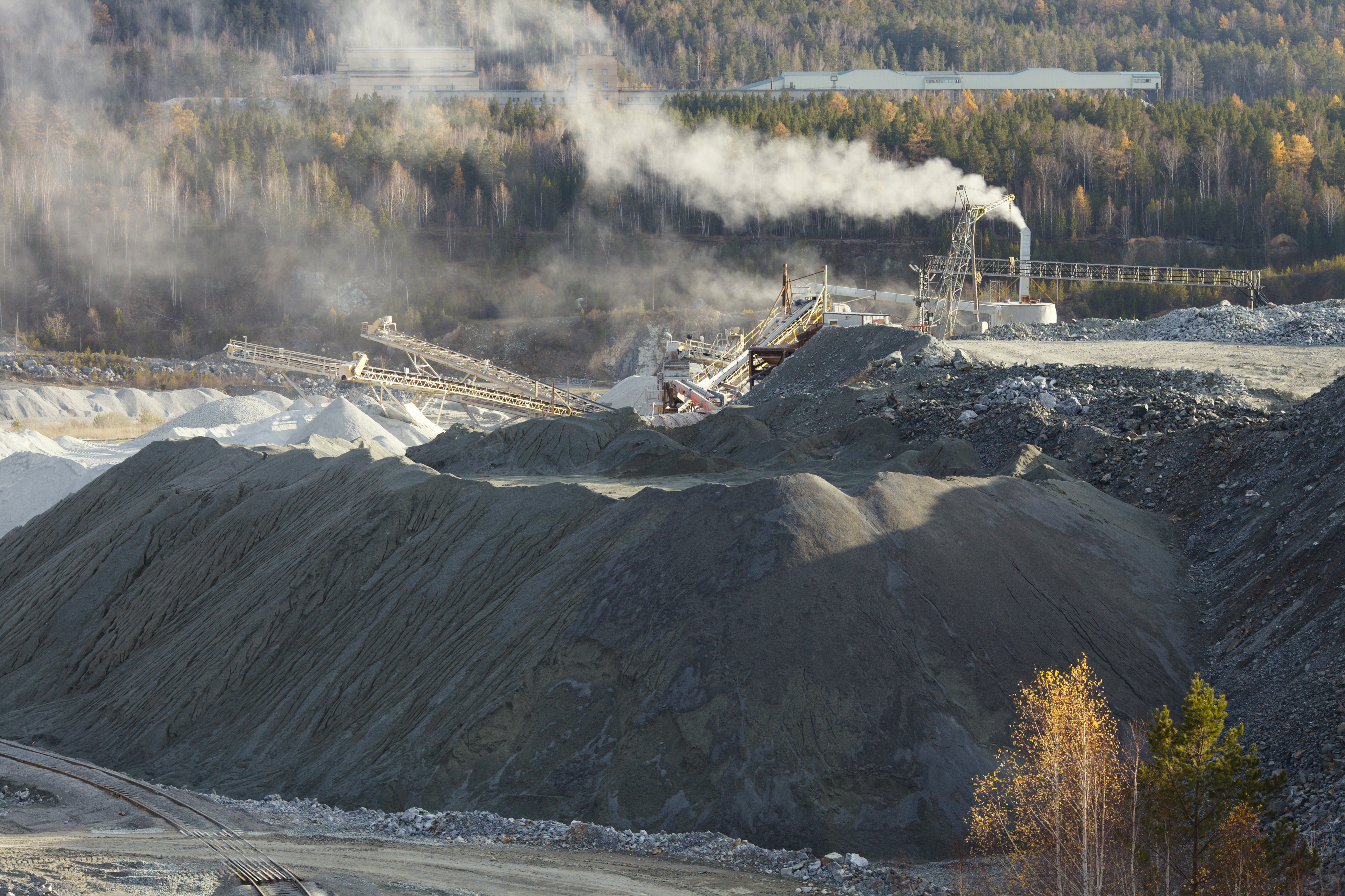 Quarry plant generating large amounts of dust, highlighting the need for quarry dust suppression.