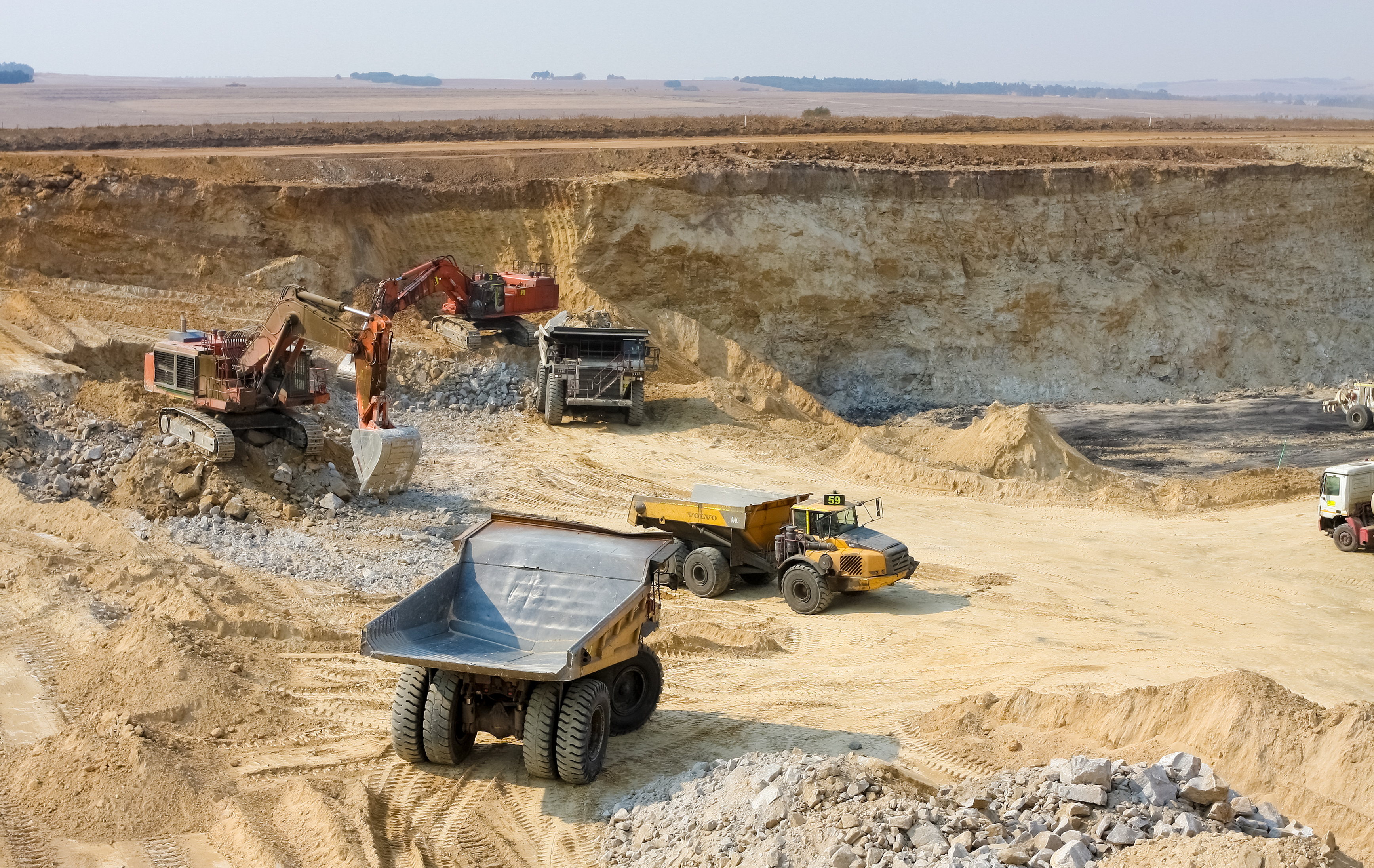 Rail freight transporting bulk materials with dust suppression roads helping reduce dust and product loss.